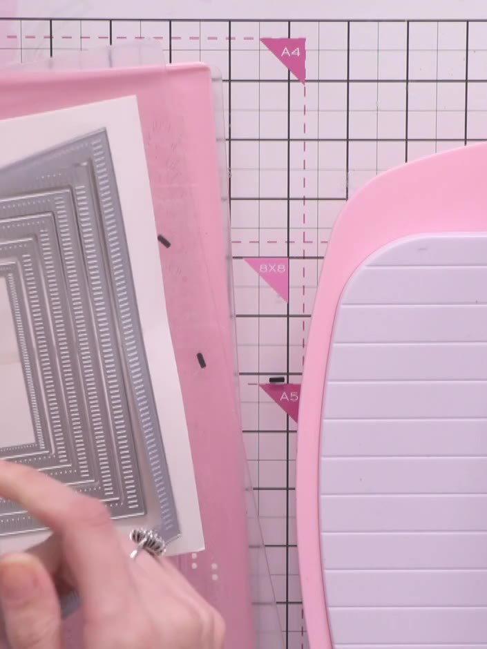 Step 1: Select the largest Corner Curve die from the nested die set. Cut two pieces of white card stock using this die