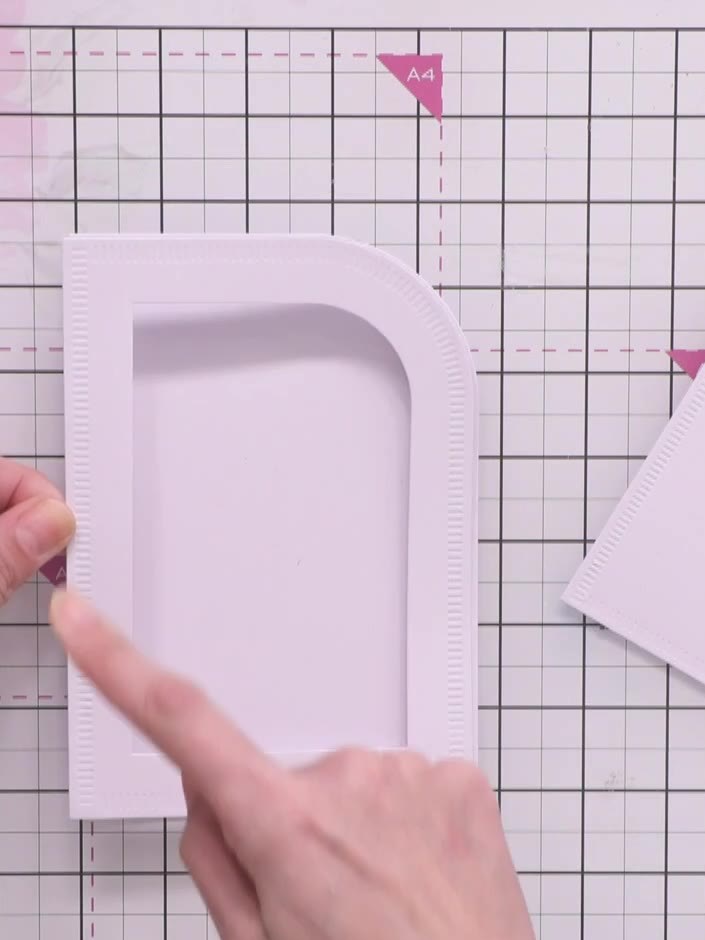 Step 8: Attach the raised frame to the card base using foam pads. Position the frame carefully on the card front, ensu