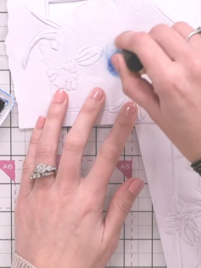 Step 3: Using a brush and light pink ink, tap colour onto the outer petals of the white daffodil piece, focusing on th