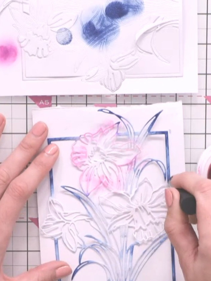 Step 4: Using a darker purple ink pad, tap colour into the centre of each flower petal on the embossed design to add d