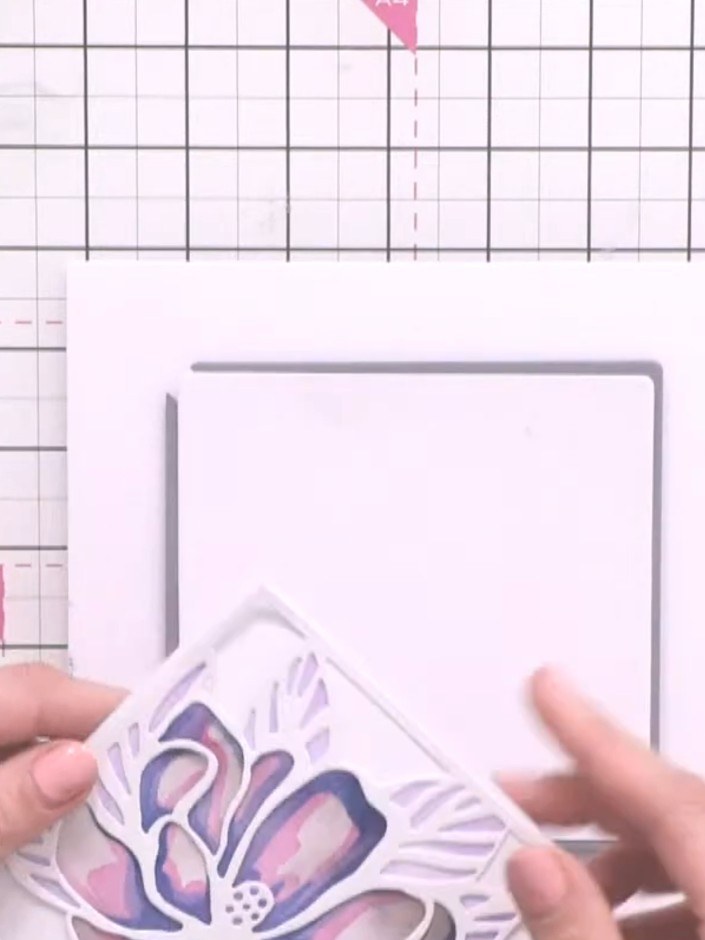Step 10: Adhere the layered magnolia flower design to your card base using foam pads for dimension. Position the flower