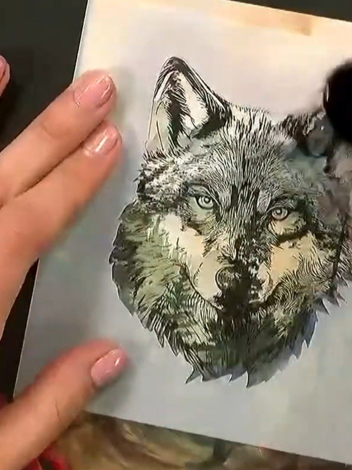 Step 6: If desired, use the exterior stencil to add additional colour or texture around the stamped wolf design. Apply