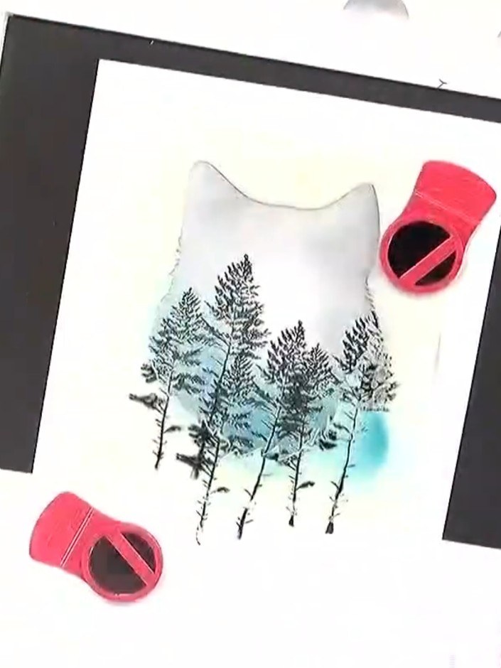 Step 6: Stamp the tree images onto the white card using black ink. Position the trees over the coloured background to 