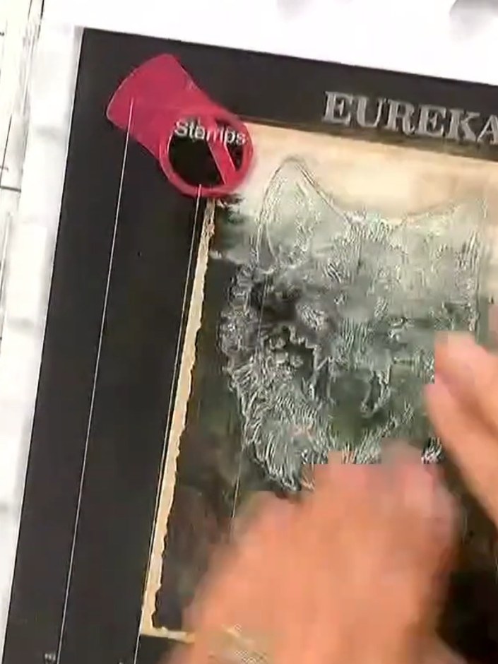 Step 2: Immediately sprinkle white embossing powder over the wet stamped ink, ensuring the entire wolf image is covere