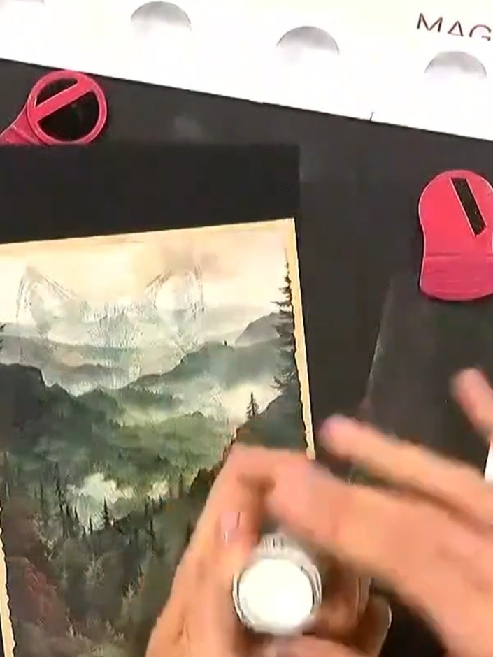 Step 3: Use an anti-static bag to brush over the stamped image, removing excess embossing powder from the black card. 
