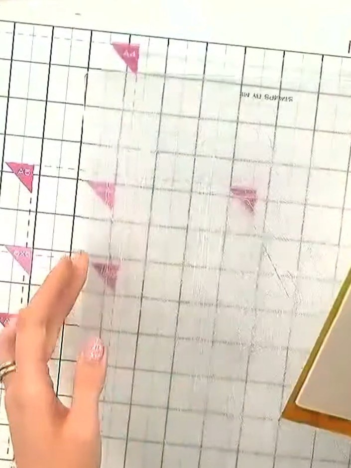 Step 1: Place a piece of metallic card stock into the embossing folder, ensuring it is centred. The card should fit co