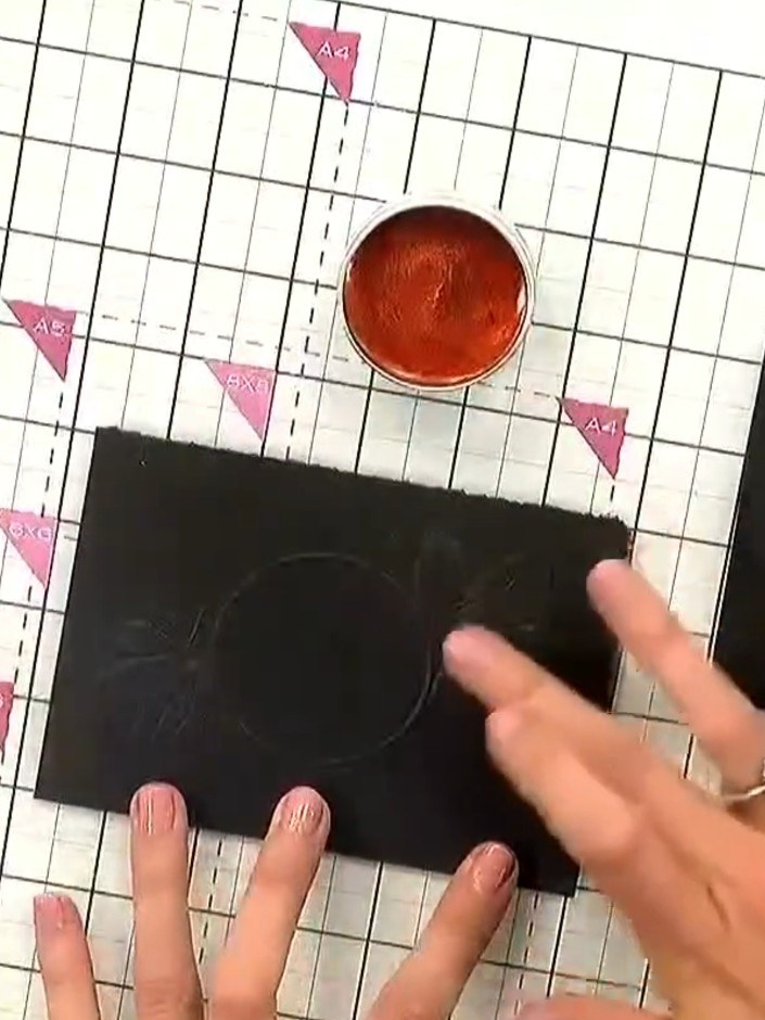 Step 2: Apply the warm wax from the pot over the embossed design on your black card, working it into the raised areas 