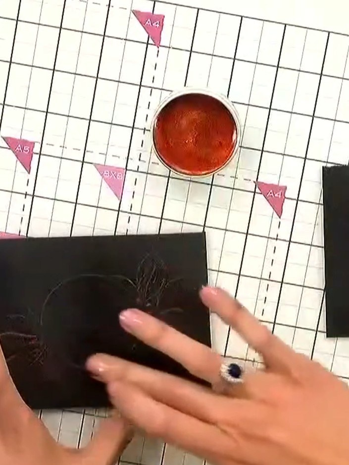 Step 3: Run your finger over the waxed embossed design to blend and intensify the colour. The wax will pick up all the