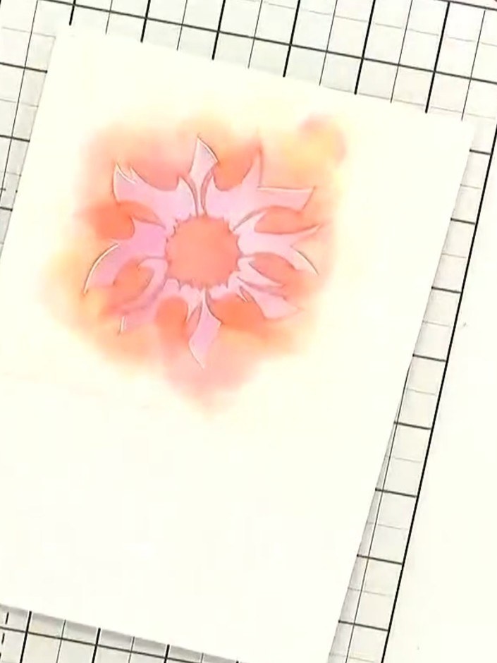 Step 5: Apply a second colour (yellow or orange) through stencil number 2 over the first layer to build up the flower 