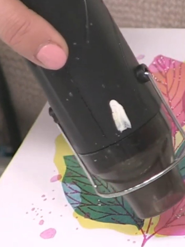 Step 10: Heat set the embossing powder with a heat gun, moving it over the design until the powder becomes shiny and fu
