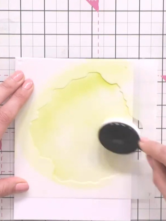 Step 2: Apply yellow ink through the first stencil using a sponge dauber, creating a base colour wash over the white c