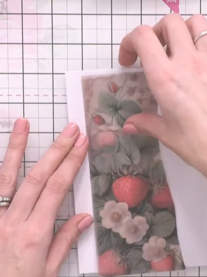 Step 3: Tear a piece of patterned vellum featuring strawberries and flowers to approximately A6 size (roughly half of 