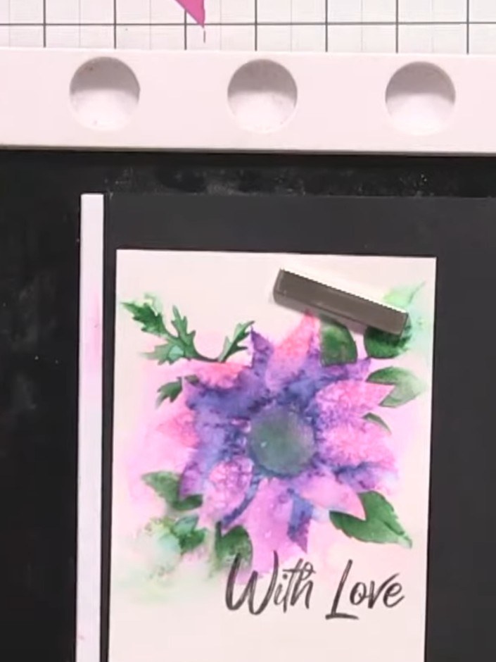 Step 14: Stamp a sentiment such as 'With Love' onto the lower portion of your card using black ink to complete your des