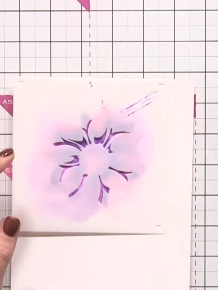 Step 8: Position stencil number 3 over your design and apply teal ink using a blending brush to add further dimension 