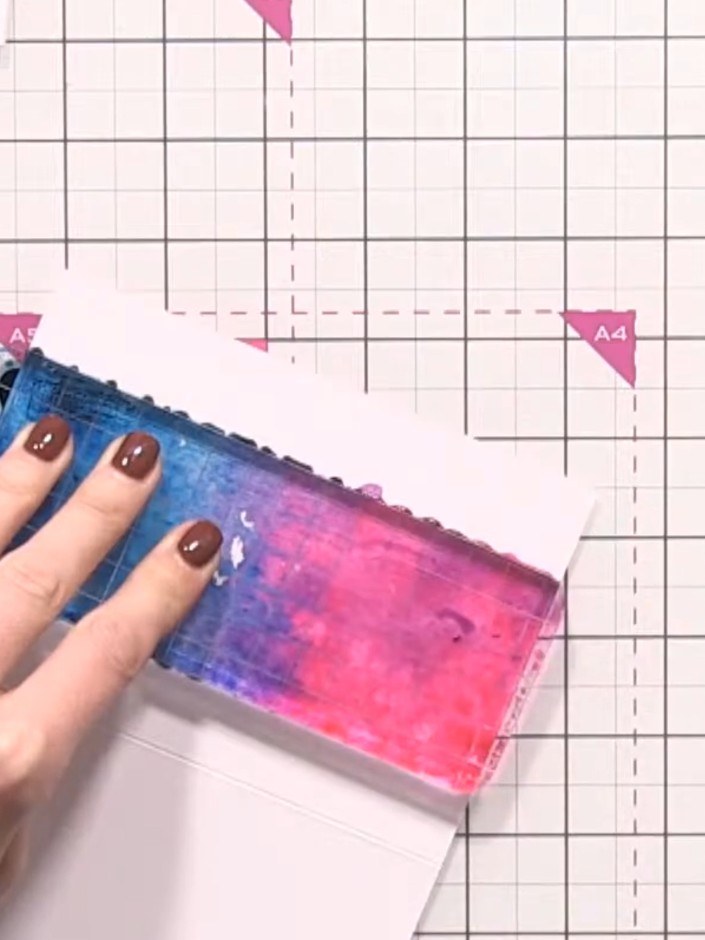 Step 7: Allow the ink to transfer fully onto the card, then carefully lift the acrylic block away to reveal the blue a