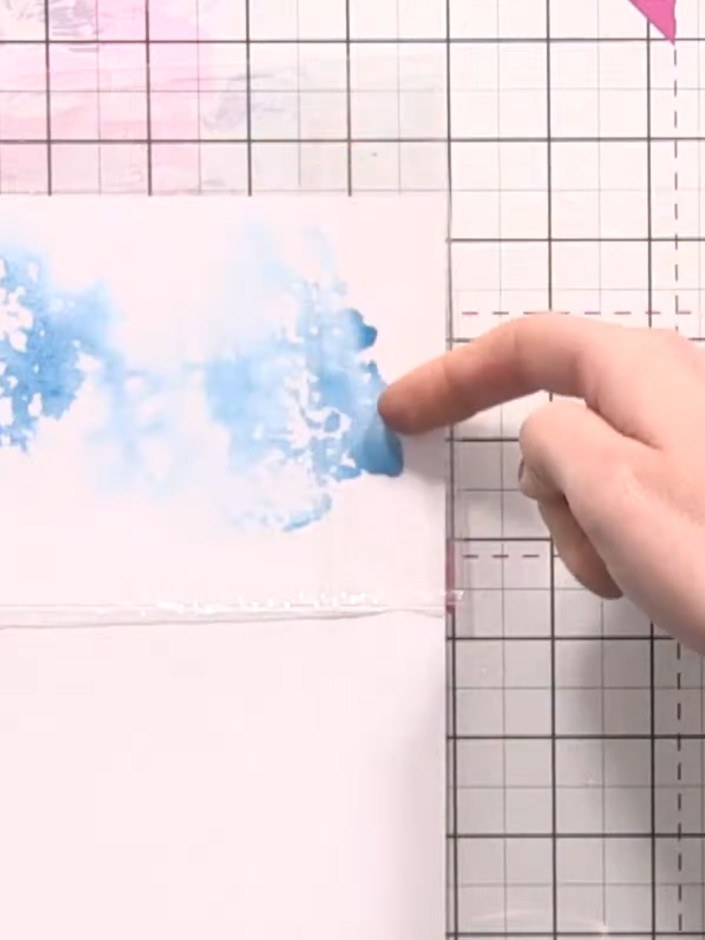 Step 4: Press the cellophane bag onto the inked craft mat to pick up the blue ink. Gently lift the bag to reveal the t