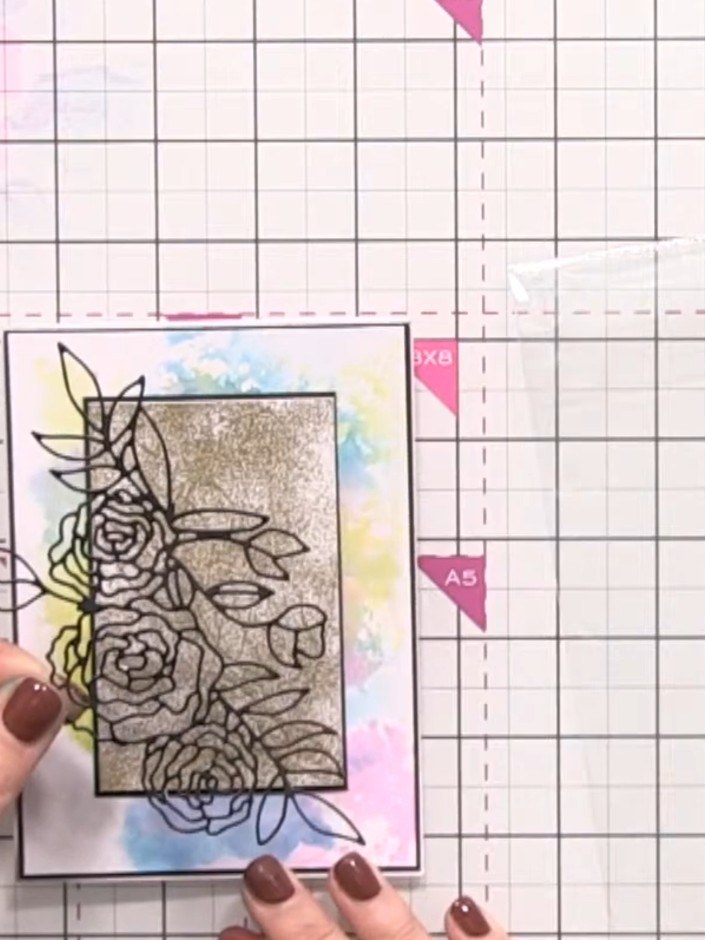 Step 12: Apply glue to select areas of the die-cut rose and position it over the glitter panel on the card front. Use a