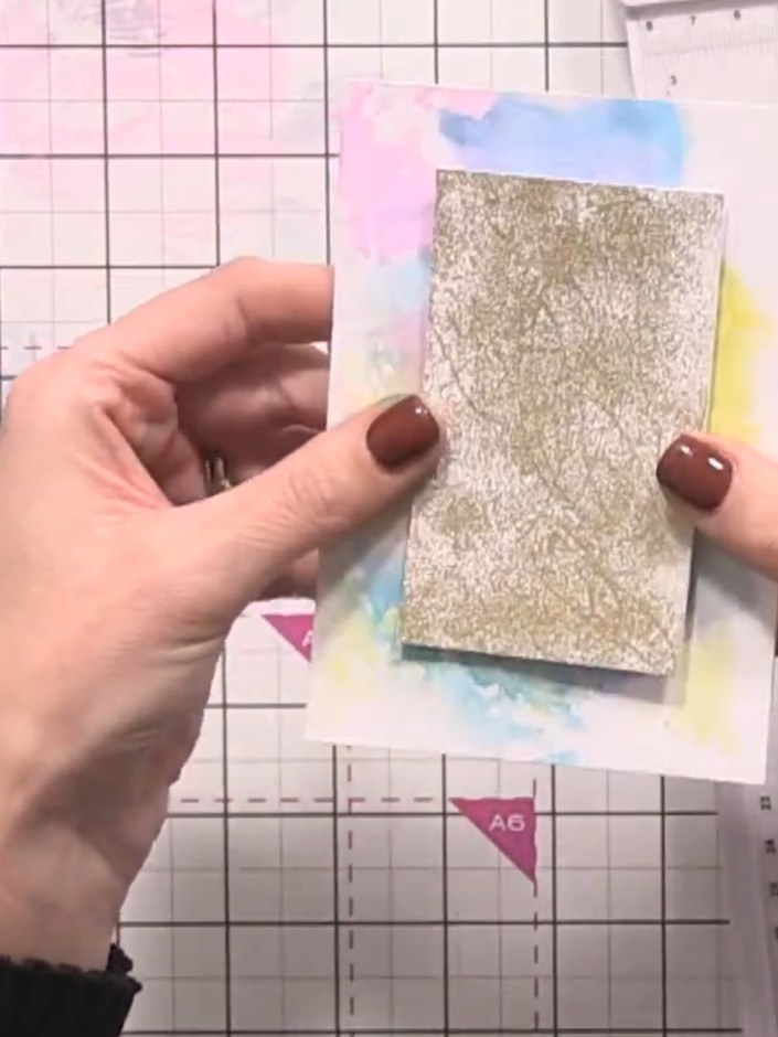 Step 4: Adhere the watercolour panel to the gold glitter card, positioning it so a thin border of gold shows around al