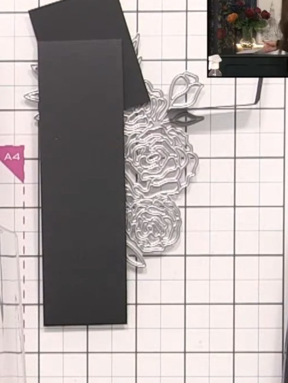 Step 7: Leg die filigrane Rosen-Stanzschablone auf schwarzen Cardstock und leg in deiner Stanzmaschine eine Stützplatte darunter.