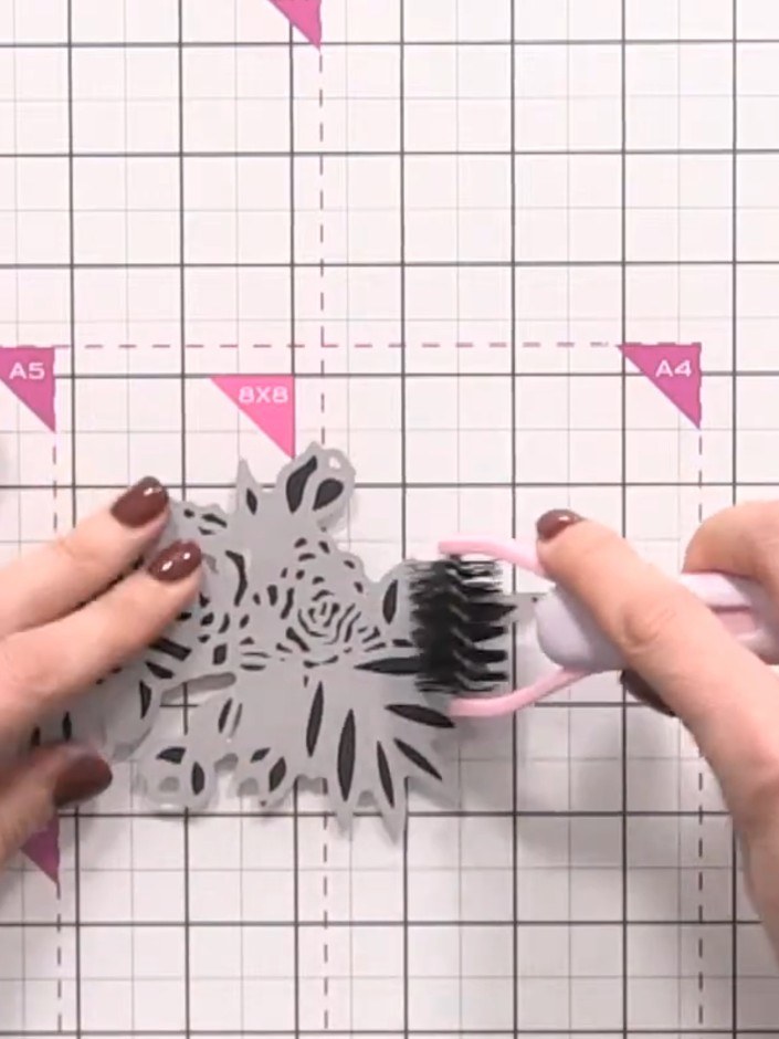 Step 9: Use a small brush to gently brush out the die-cut rose pieces, helping to release any intricate cut sections f