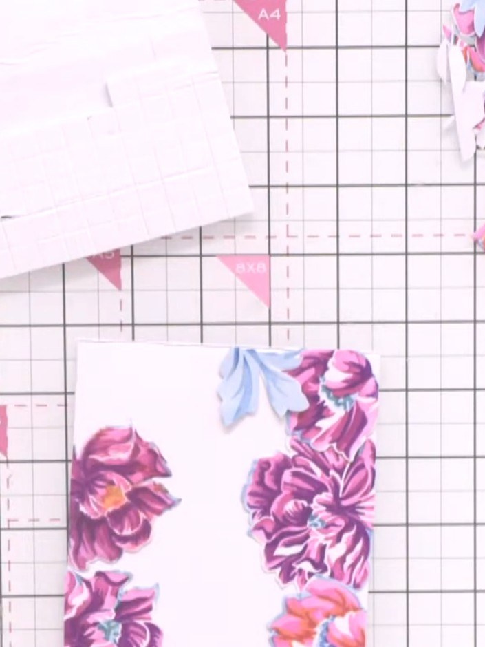 Step 11: Apply foam pads to the back of each die-cut flower piece. This will create dimension and raise the flowers fro
