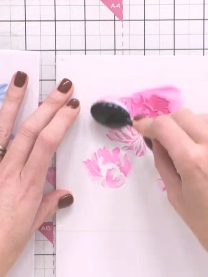 Step 3: Position stencil number two over the first layer. Apply the same pink ink using the blending brush, pressing s