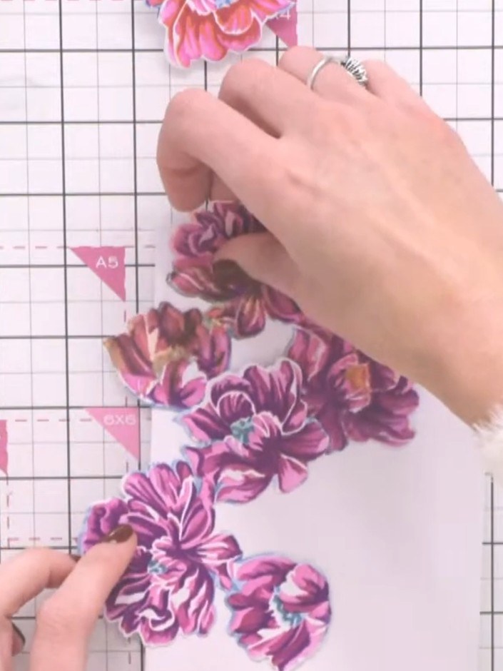 Step 8: Using scissors, carefully cut around the individual flower elements to separate them from the card base. Cut o