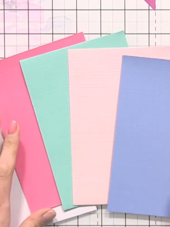 Step 1: Gather a card blank and four pieces of coloured card stock in soft pastel shades: white, pink, mint green, pal