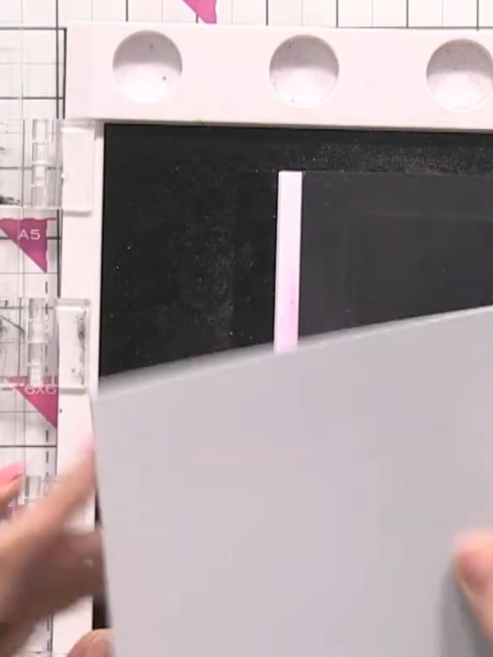 Step 3: Position your white card blank in the corner of the Eureka stamping system to hold it steady for stamping.