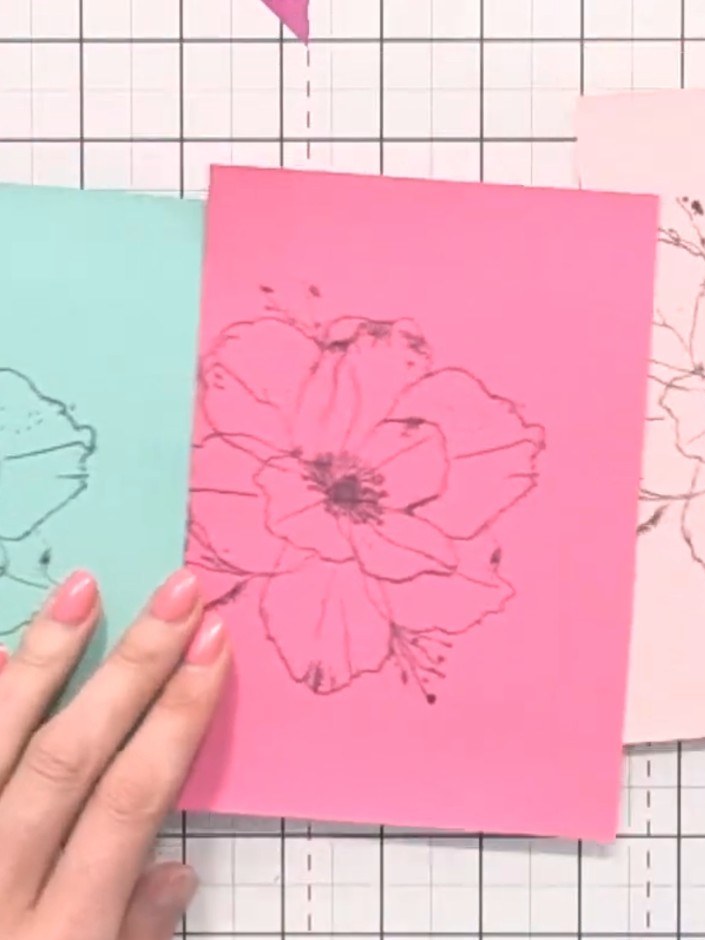 Step 1: Gather your four stamped poppy pieces on different coloured card stock: mint green, pink, pale pink, and blue.