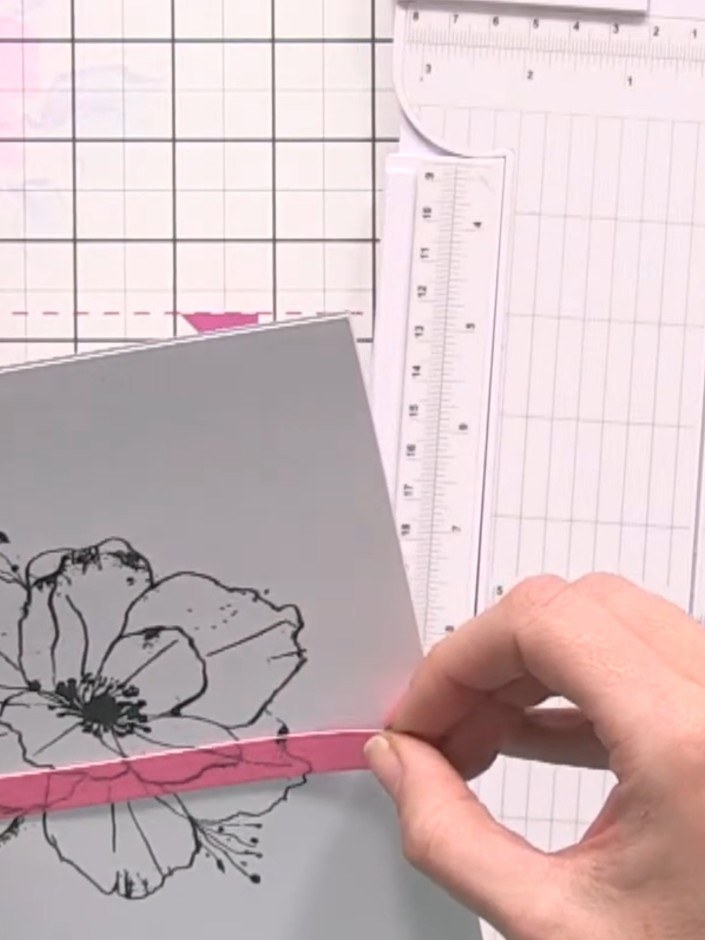 Step 4: Take your card blank and apply the first pink strip along the top edge, carefully aligning it with the stamped