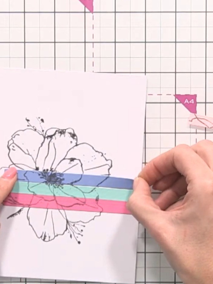 Step 7: Trim the assembled card to create clean edges using a paper trimmer or scissors. Remove any excess paper from 