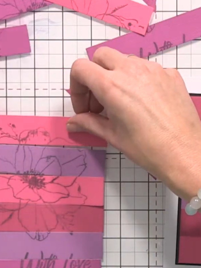Step 3: Adhere the rearranged strips to your black card base, ensuring the floral design lines up correctly across the