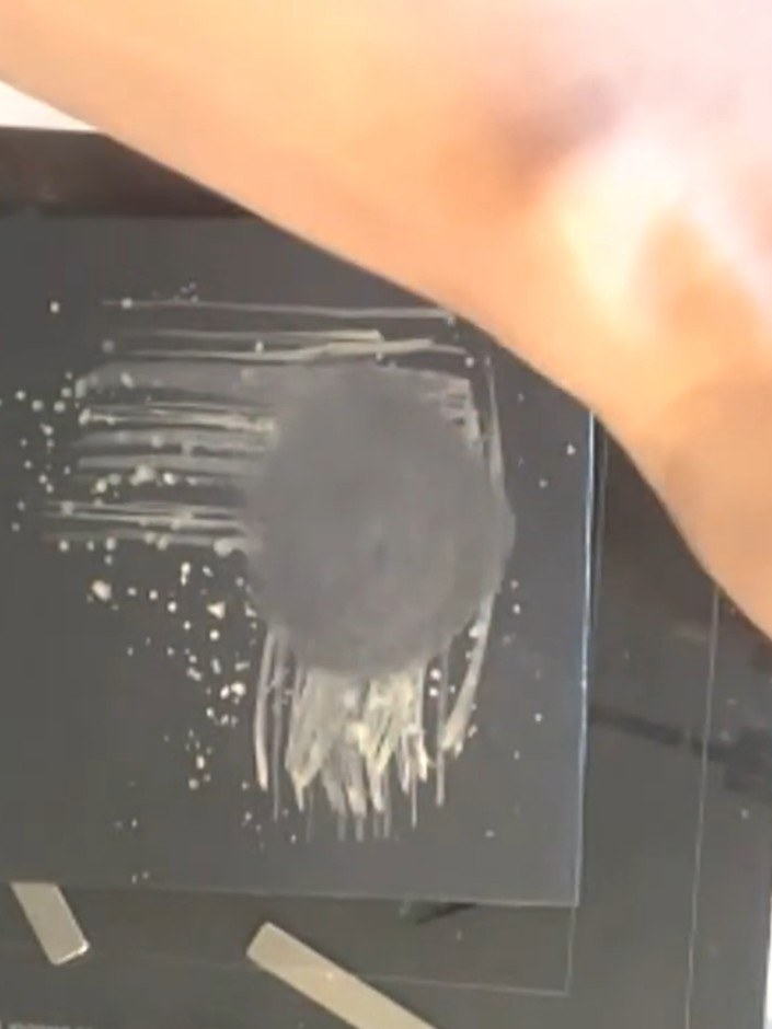 Step 4: Use a fan brush to flick metallic watercolour across the top of the black background to add texture and visual
