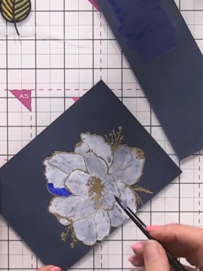 Step 10: Using blue watercolour, paint the outer edges of each petal on the flower. Work on one petal at a time, carefu