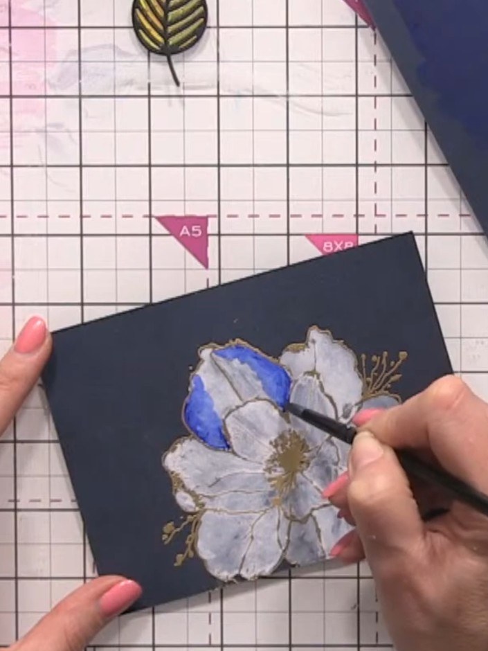 Step 11: Clean your brush and dampen it with water. Blend the blue coloured edges inward toward the white centre of the