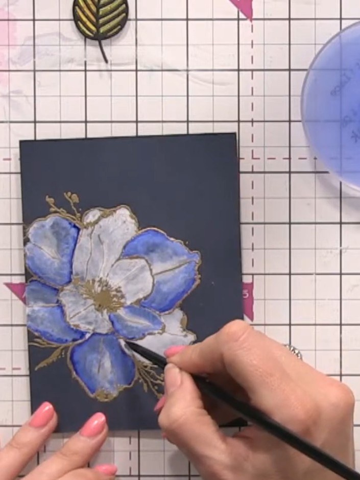 Step 12: Once the paint is dry, add additional definition to the flower by painting darker blue details in the creases 