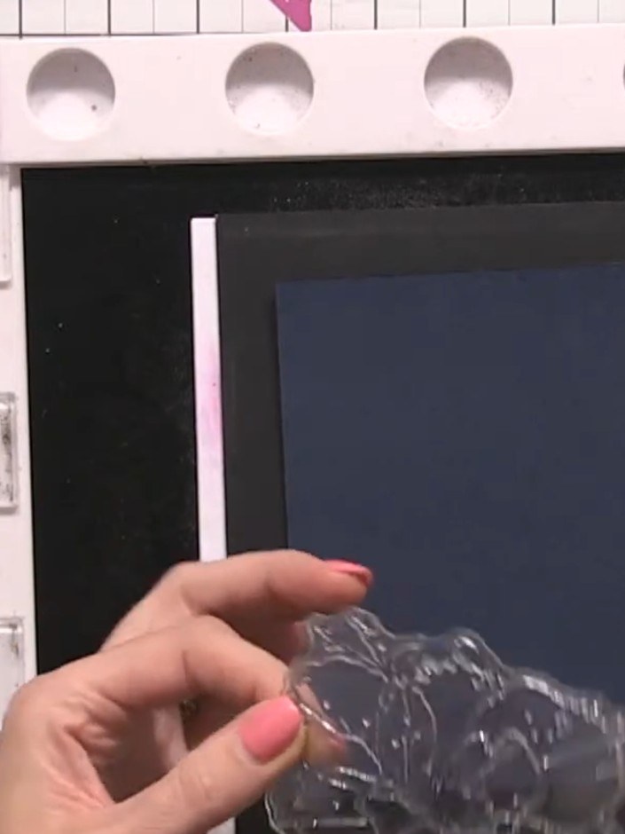 Step 4: Apply gold embossing powder to the stamped image, ensuring it covers all the details and splats. Tap off any e