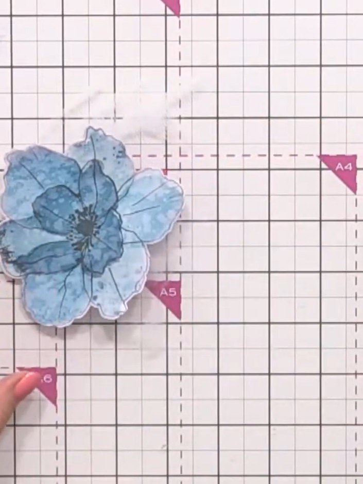 Step 12: Swipe a dark ink pad across the blue flower in one direction to create a brushed wood effect and add further d