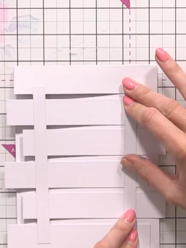 Step 6: Cut your wood-grain patterned paper to size and layer it behind the wooden panel strips, ensuring the paper is