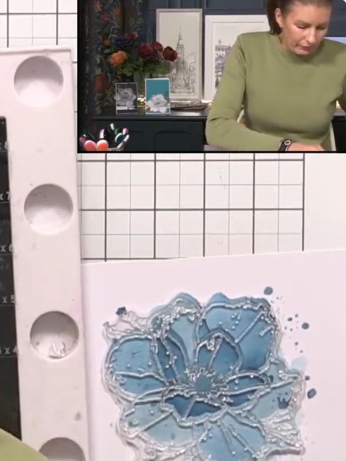 Step 8: Using the coordinating stamp from the Forever Lilies set and a black ink pad, stamp the flower outline onto th