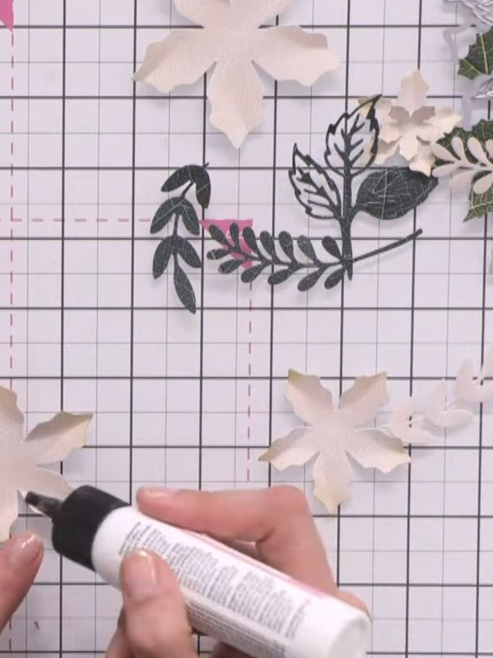 Step 6: Die-cut foliage pieces from green cardstock using the Holly and Berry foliage die set. Use varying shades of g