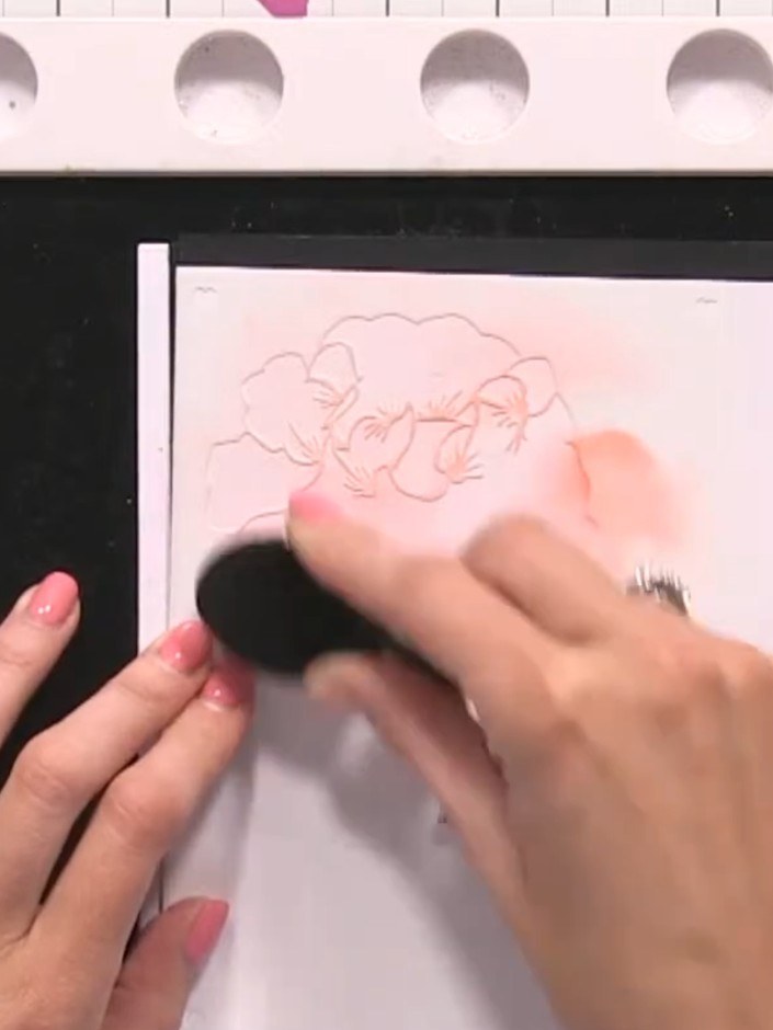 Step 4: Apply orange ink to the embossed floral design using a blending tool with a circular motion. Work the colour i