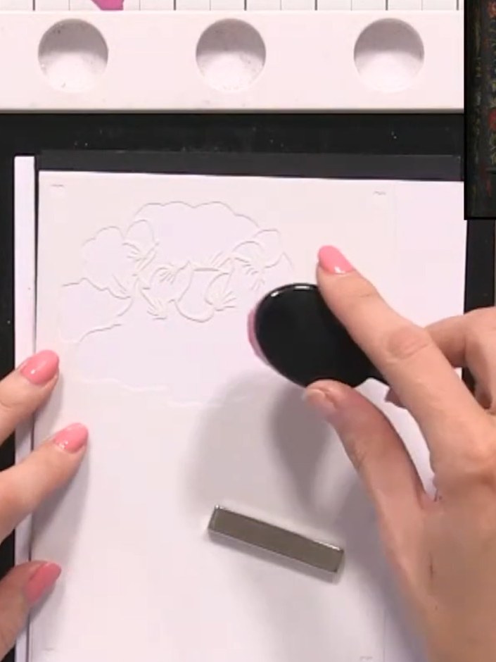 Step 2: Using a blending brush, lightly apply orange ink through the embossed stencil onto the card. Use gentle circul