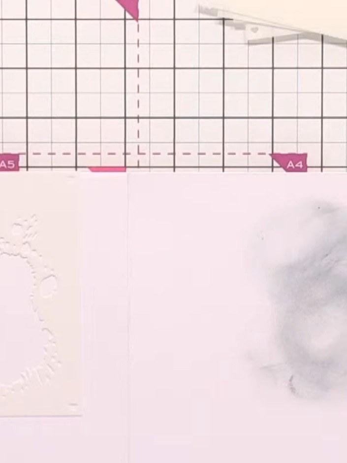 Step 2: Apply stencil number one using a light grey ink pad and blending brush, creating splat details around the edge