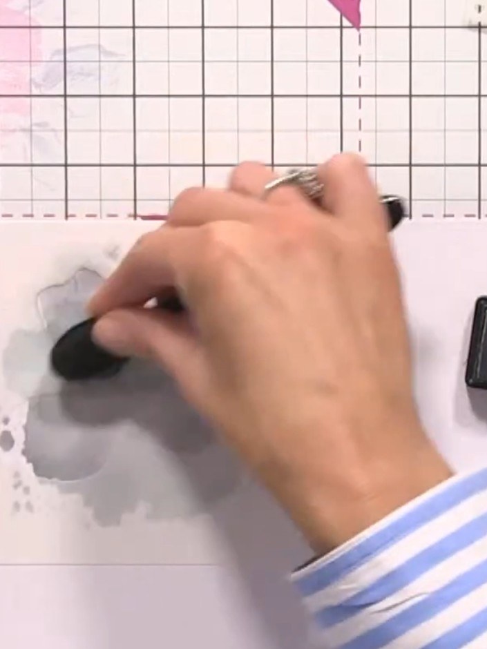 Step 3: Press stencil number two onto the card with slightly more pressure to create a watermark effect in the same gr