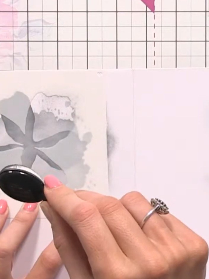 Step 4: Stamp the large flower outline onto the card using grey ink. Lightly spray with water to create a bleed effect