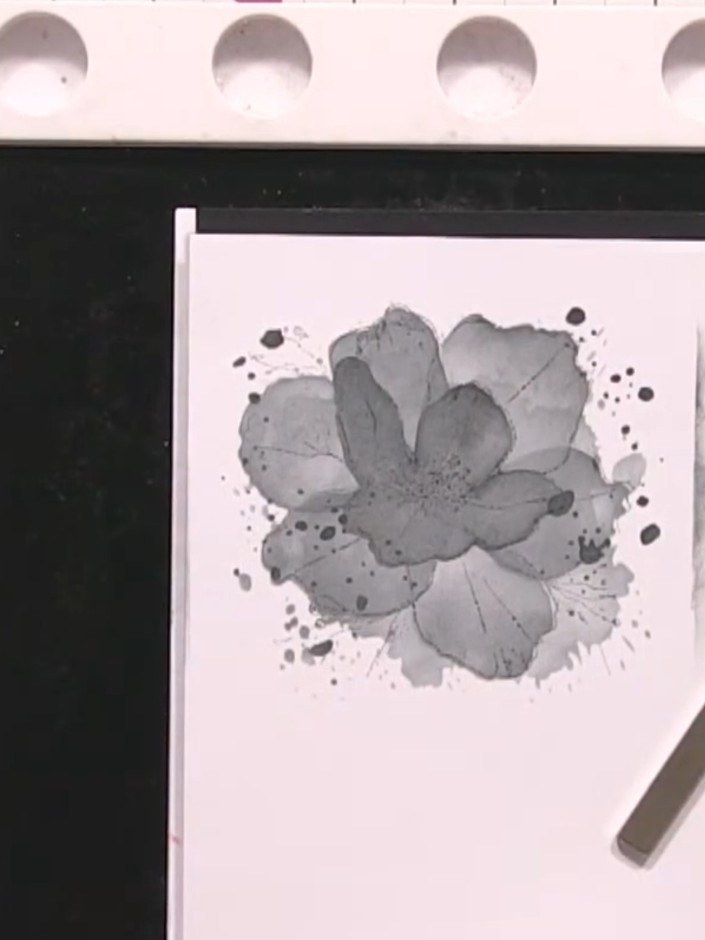 Step 5: Stamp over the same flower outline again using black ink to create an abstracted, layered effect with the grey