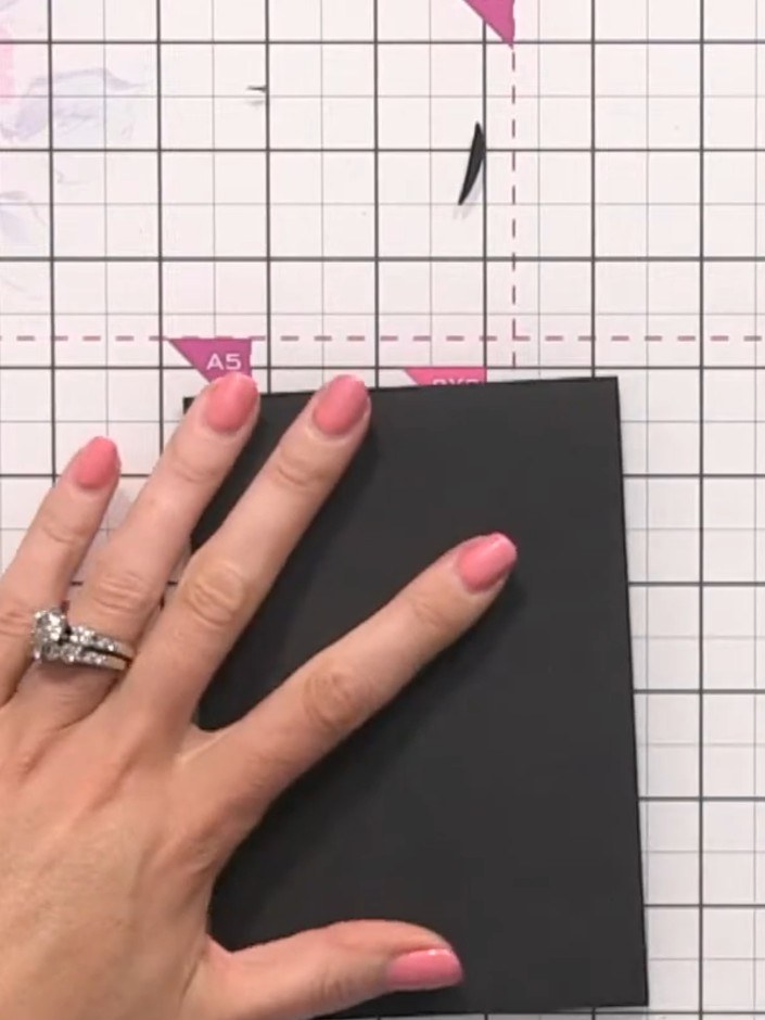 Step 7: Score white card in half to create a small card base. Layer a piece of black card onto the front of the card b