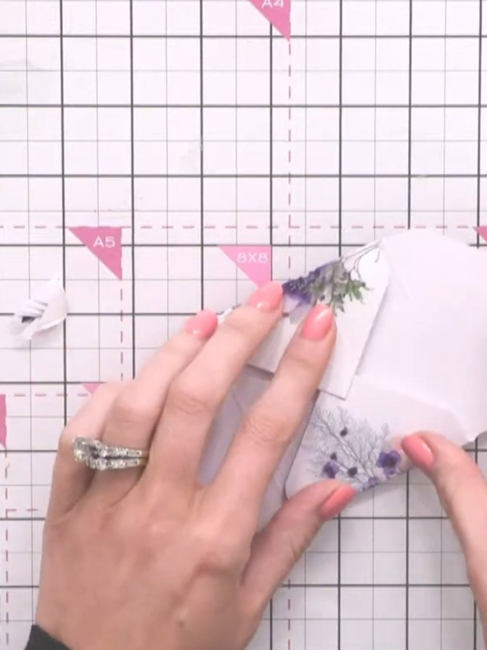 Step 9: Fold in the side flaps of the envelope and secure them with double-sided tape to create the envelope shape.